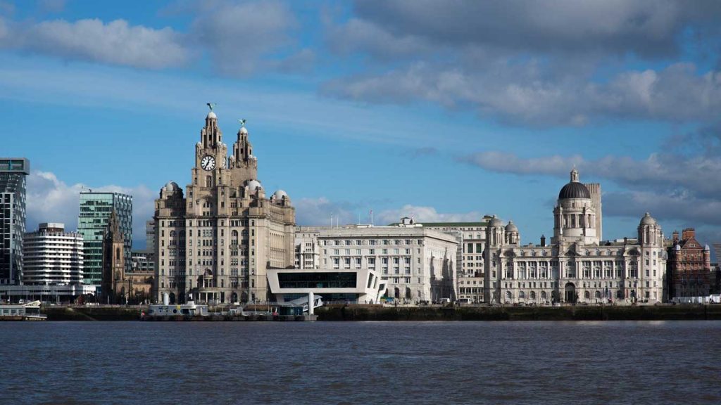 Liverpool cityscape by the river and liver building, Blog post UK Universities Surge Up World League Table, Fresh Start UK, investment immigration visa in The United Kingdom, England, Scotland - Middle East, Dubai, Cairo.